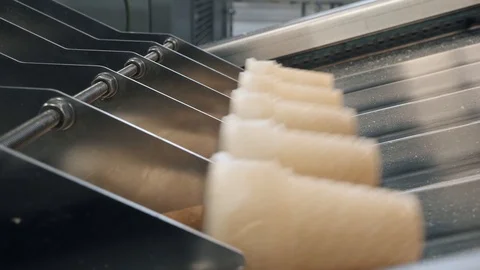 Waffle cups move along production line at ice-cream plant Stock Footage 124608070