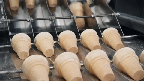 Waffle cups put on conveyor equipment distributing in rows Stock Footage 124608055