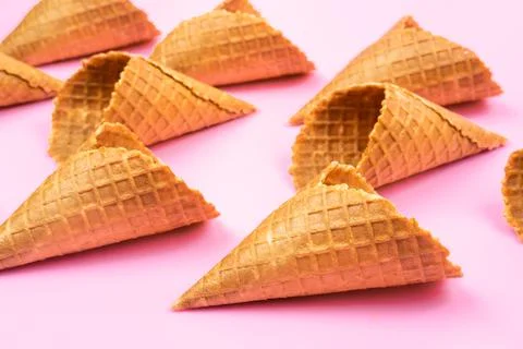 Waffle empty ice cream cones on a colored pink background Stock Photos