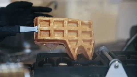 Waffle Maker Being Used in a Cozy Kitchen Setting at Christmas market in Colo Stock Footage 345757900