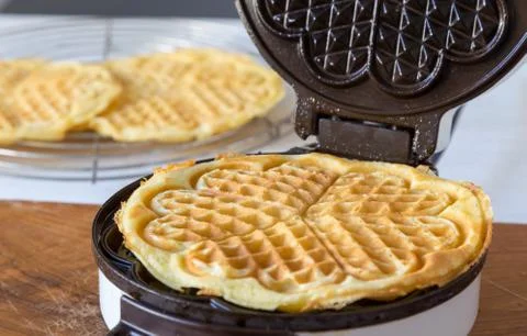 Waffle makers in operation Stock Photos