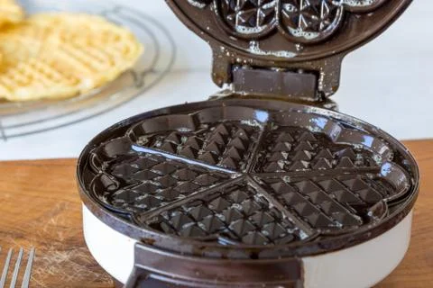 Waffle makers in operation Stock Photos