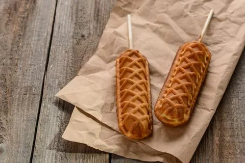 Waffle pops on kraft paper on a rustic wooden table Stock Photos