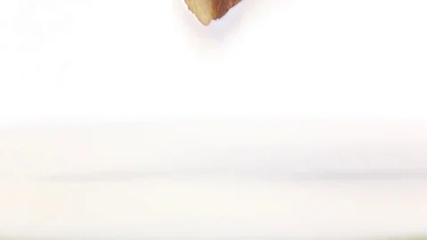 Waffle stick stirs white milk in slow motion. Super closeup Stock Footage