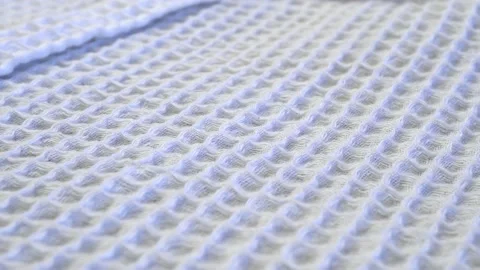 Waffle texture of white fabric. Slide shot macro texture of a men's waffle ba Video stock 203822091