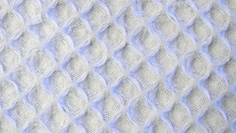 Waffle texture of white fabric. Slide shot macro texture of a men's waffle ba Stock Footage 203822520