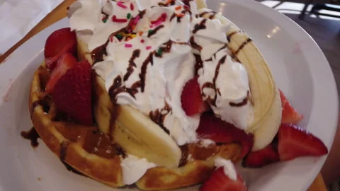 Waffle topped with fresh fruit and cream Stock Footage 157344374