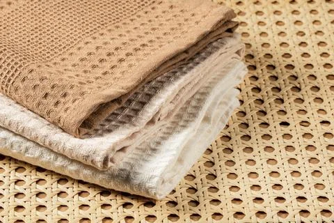 Waffle towels folded in a stack on a rattan mat background Stock Photos