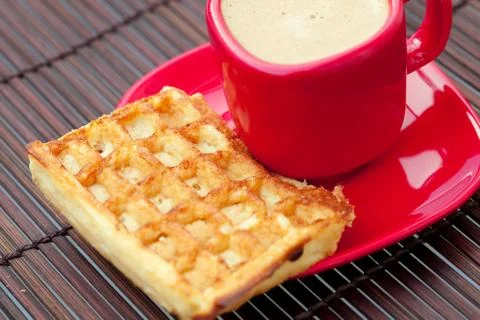 Waffles and cappuccino on a bamboo mat Stock Photos