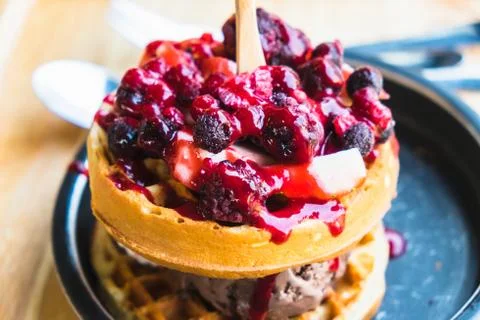 Waffles and chocolate icecream with fresh berries on wooden tray Stock Photos
