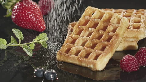 Waffles being sprinkled with Sugar Stock Footage 135641484