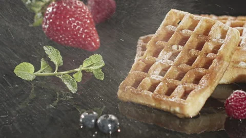 Waffles being sprinkled with Sugar Stock Footage 135656341