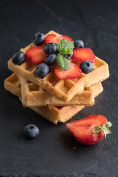 Waffles with berries. Stock Photos