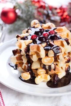 Waffles with chocolate sauce and winter berries for christmas Stock Photos