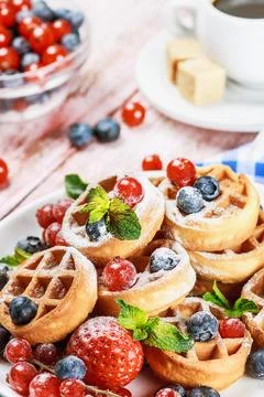 Waffles with fresh berries on the table Stock Photos