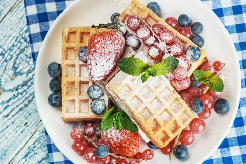 Waffles with fresh berries on the table Stock Photos