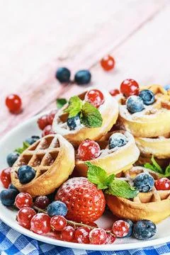 Waffles with fresh berries on the table Stock Photos
