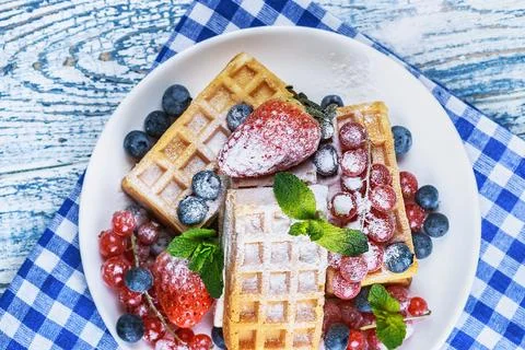 Waffles with fresh berries on the table Stock Photos