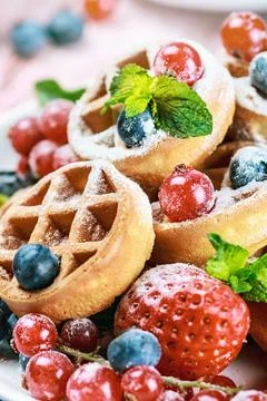 Waffles with fresh berries on the table Stock Photos