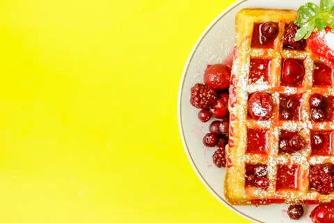 Waffles with red berries Stock Photos