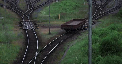 A wagon runs on rails in a freight yard Vidéo 263043535