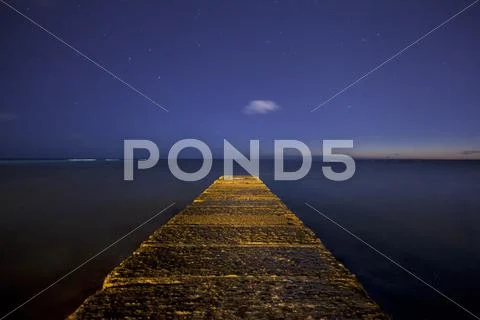 Waikiki beach jetty with star filled night sky Stock Photos