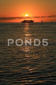 Waikiki Sunset with Boat Vertical Stock Photos