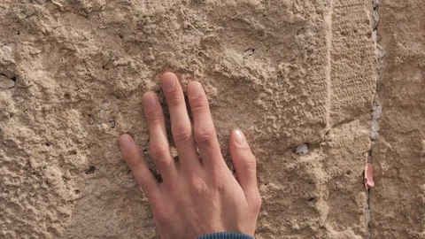Wailing Wall or Western Wall in Jerusalem. Close-up of a hand tuching stones Video stock 127749989