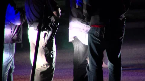 Waist-down medium shot at night with police officers at actual crime scene. Stock Footage 45503282