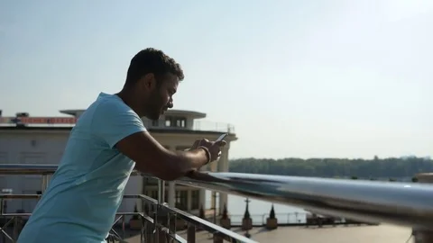Waist up of positive Indian man leaning on the railing Stock Footage