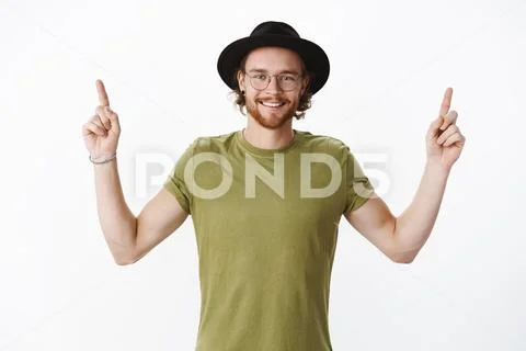 Waist-up shot of good-looking happy charismatic redhead bearded guy in hat and Stock Photos