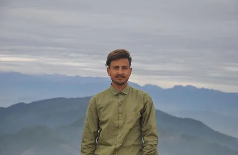 Waist up of a young guy looking at camera while standing against the background  Foto stock