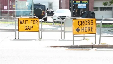 Wait for gap and cross here with arrow writing caption text street road signs Stock Footage 252043334