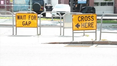 Wait for gap and cross here with arrow writing caption text street road signs Stock Footage 252043407