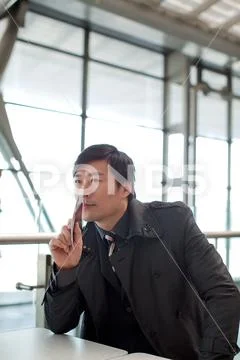 Wait Rest Thinking Indoor Journey Airport Consider Asians Business people Stock Photos