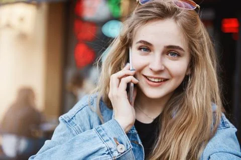 Wait sec need answer on call. Portrait of busy good-looking female freelancer in Stock Photos