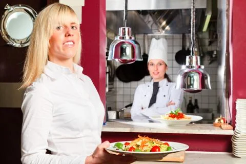 Waiter And Chef Posing In Front Of The Kitchen 写真素材