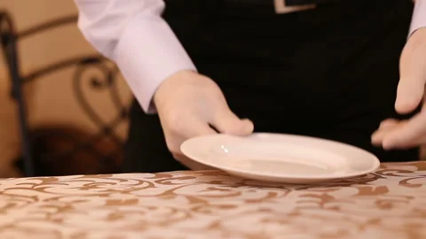 A waiter arranges the plate, knife, fork and glasses of crystal 스톡 동영상 96083767