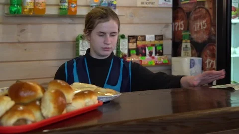 The waiter behind the counter, a stack of pies lies on the counter Video stock 123044308