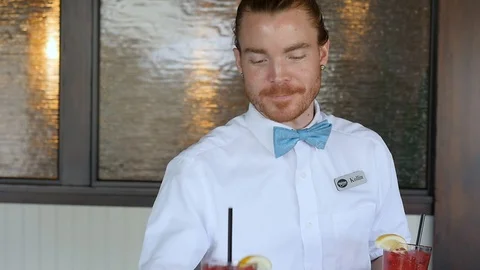 Waiter brings drinks to table of young couple slow motion Stock-Footage 94238570