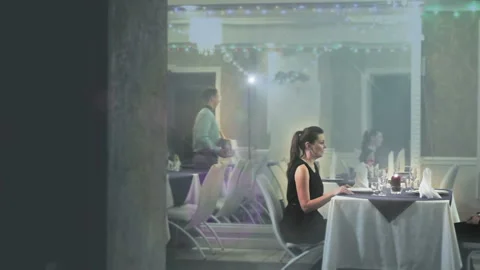 A waiter brings a middle-aged guy with a bucket of champagne, gives the man to Stock Footage 97575839