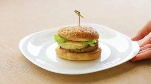 The waiter brought a plate with a hamburger with pineapple 스톡 동영상 65930087