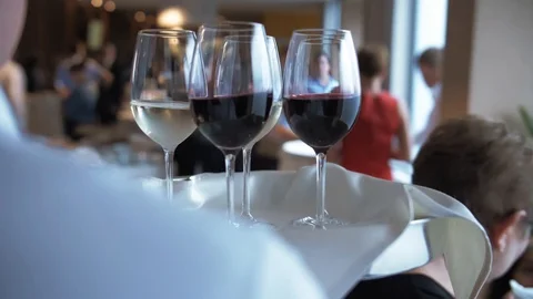 Waiter Carries Red and White Wine on a Tray Stock Footage