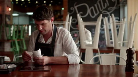 Waiter checking receipts at cafe. Stock Footage 64099537