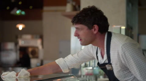 Waiter cleaning cafe counter. Stock Footage 64098247