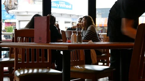 Waiter cleaning a table after customers at the restaurant Stock Footage 85654028