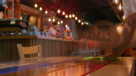 Waiter cleaning the table with spray disinfectant on table in