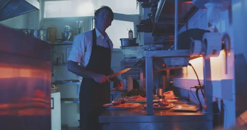 Waiter communicates to chef in professional kitchen Stock Footage 203559967