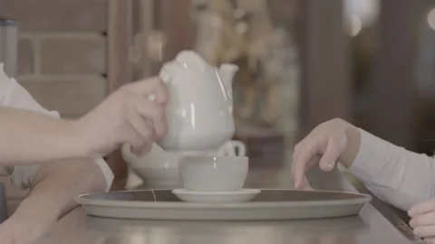 Waiter with a Cup of tea in the restaurant Slow motion Stock Footage 239399836