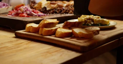 The waiter cuts the finished meat and runs the table in the restaurant Stock Footage 277477601